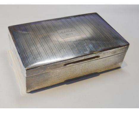 Silver cigarette casket with engraved engine turned hinged top, the interior with cedar-lined compartments, 7cm high and 23cm