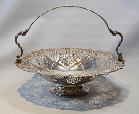 Silver circular cake basket with swing handle, pierced and embossed, by Harrison & Howson, Sheffield 1853, 30cm, 656g.CONDITI