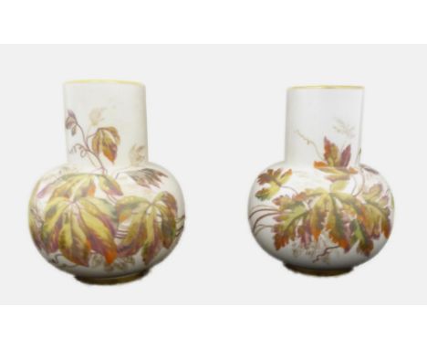Pair of Royal Worcester porcelain vases, c. early 20th century, painted with foliage to the neck and lower, gilt rim, shape n