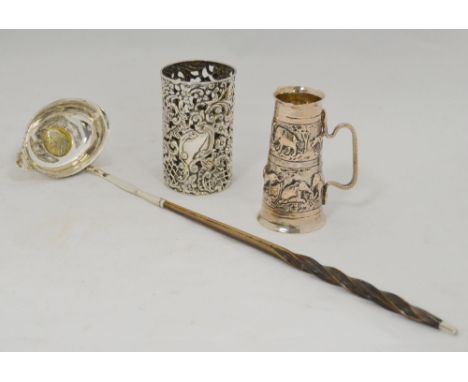 Indian silver embossed double measure, silver bottle holder, and a silver toddy ladle with inset shilling and baleen handle, 