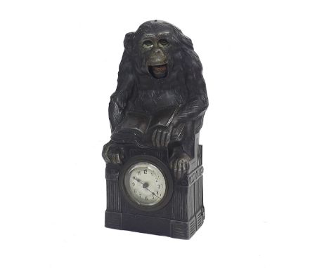 Novelty automaton clock timepiece in the form of a monkey with moving eyes and mouth, reading a book upon a pedestal enclosin