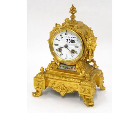 French gilt metal two train drumhead mantel clock striking on a bell, the 3" white dial over a small porcelain panel to the r