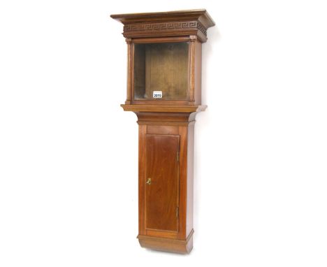 Contemporary mahogany wall clock case with aperture for a 7.5" square dial, the trunk with long door and the hood surmounted 