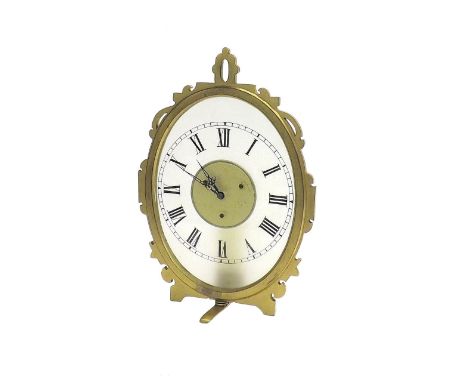 Brass night clock timepiece, the opaque oval dial within a strut type surround, before a candlelight holder, 7.25" high