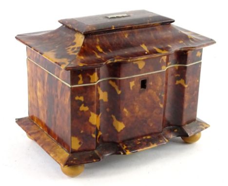 An early Victorian tortoise shell and ivory tea caddy, the pagoda shaped hinged lid enclosing two lidded compartments on bun 