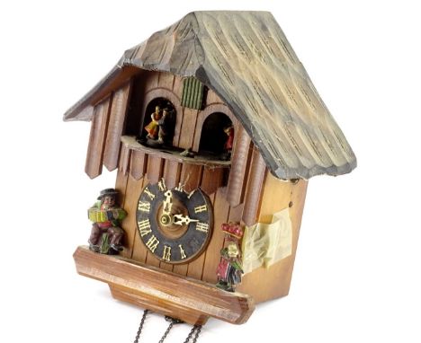 A Swiss type cuckoo clock, decorated with composition figures etc. (AF)