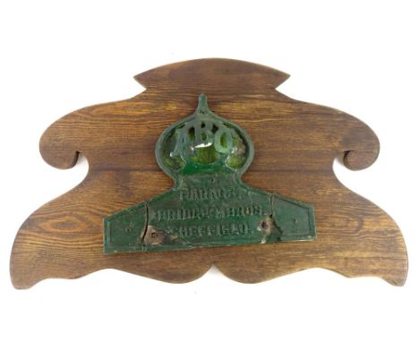A late 19th/early 20thC automobile garage sign, for Bridges Brothers of Sheffield, on later wooden plaque (AF), 68cm W overal