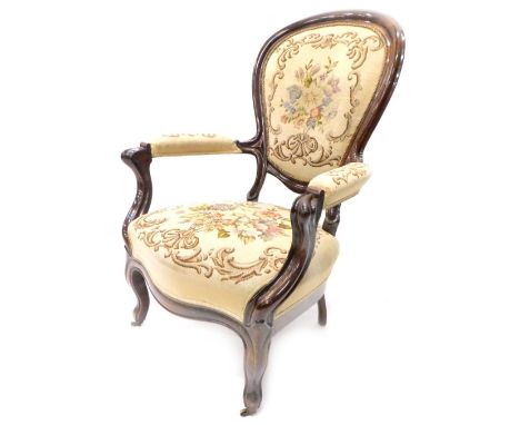 A 19thC mahogany show frame armchair, with a wool work padded back, armrest and seat, on cabriole legs with ceramic castors.