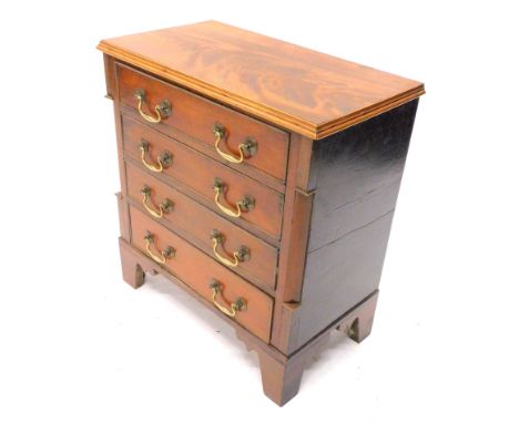 A mahogany apprentice chest of drawers, the top with a moulded cornice above four drawers, flanked by rounded corners on brac