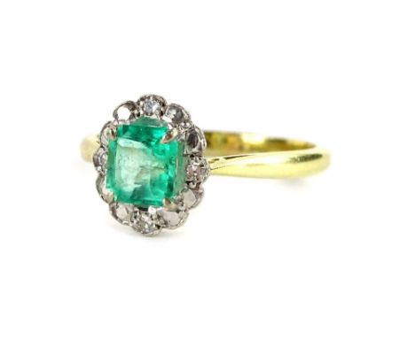 An 18ct gold emerald and diamond cluster ring, with square cut emerald in claw setting, surrounded by design of four tiny dia