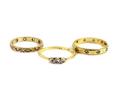 Three rings, to include an 18ct and plat three stone dress ring, 1.6g, and two 9ct gold eternity rings, each stone set (AF), 