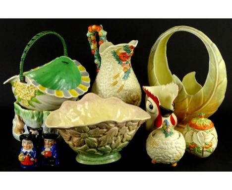 A Clarice Cliff preserve jar and cover, moulded with wheat, fruit etc., a similar jug, a jug moulded as a cockerel etc.