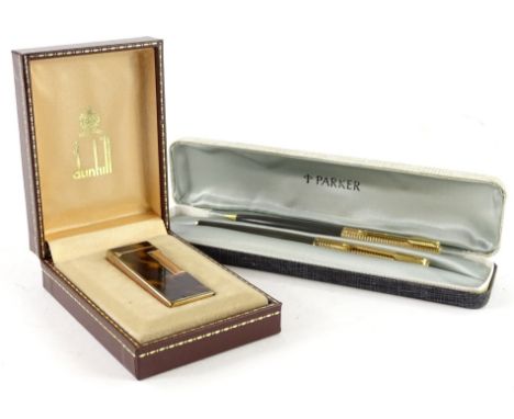 A Dunhill lighter, with simulated tortoise shell decoration, and a Parker pen set in original box. (2)