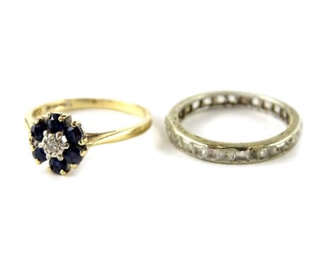 Two dress rings, to include a 9ct gold cluster ring, with blue and white stones, and a silver plated eternity ring. (2)