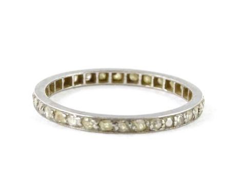 A thin diamond eternity ring, set with tiny old cut diamonds, in white metal setting, unmarked, ring size O, 1.8g all in.