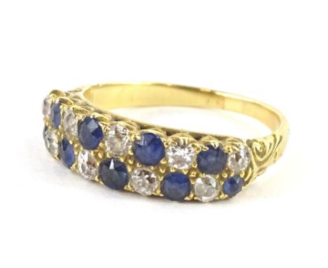 A sapphire and diamond ring, with two row design of round brilliant cut stones, each in claw setting, alternating stones, wit