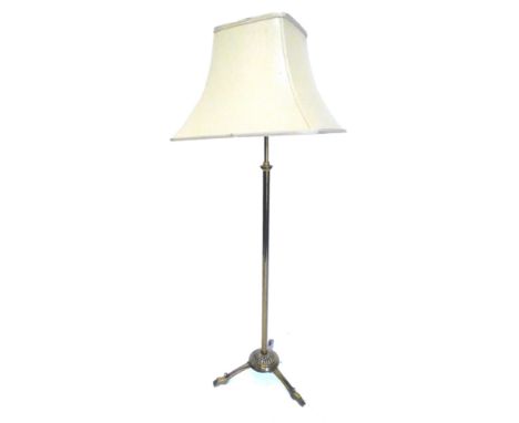 An Edwardian adjustable brass floor lamp, on tripod base, adapted from an oil lamp, 151cm H.