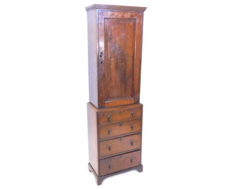 A mahogany bachelors type cabinet, the top with a dental cornice above a single panel door, the base with four drawers, each 