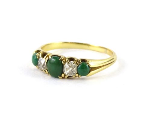 A jade and diamond dress ring, set with three jade stones, one central oval cut, and two round cut, with two old cut diamonds