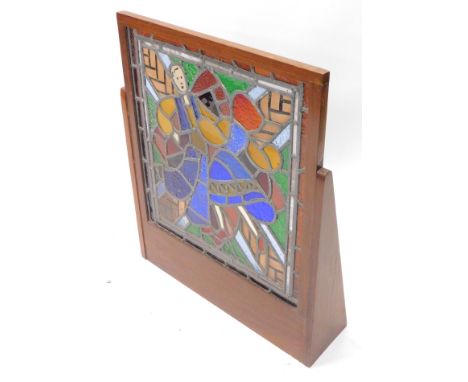 A stained glass panel, decorated in the form of a lady wearing a flowing dress etc., mounted in a hardwood frame, 62cm W over