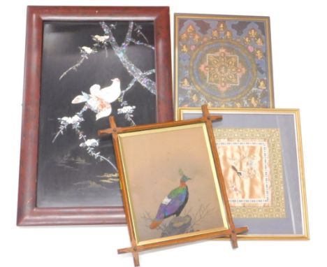 An Oriental lacquered panel, inlaid in mother of pearl with birds, trees etc., on a black ground within a red lacquered frame