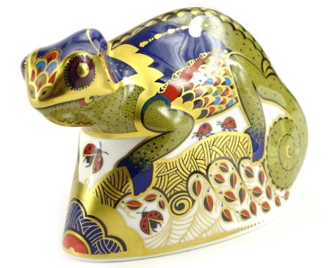 A Royal Crown Derby porcelain chameleon paperweight, decorated in Imari colours, printed mark in red to underside and silver 