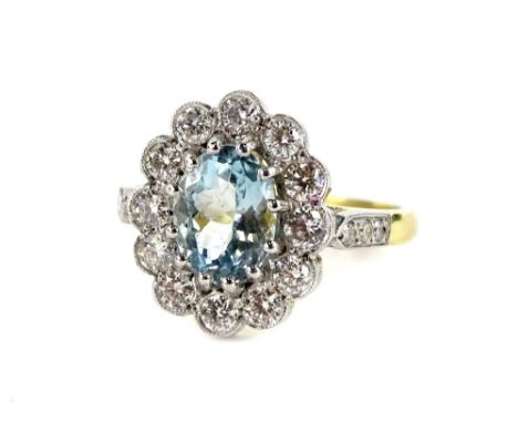 An 18ct gold and platinum aquamarine and diamond daisy ring, with oval cut aquamarine, in claw setting, 6.2mm x 8.4mm x 4.8mm