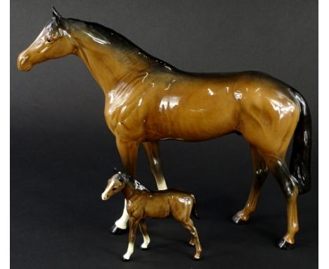 A Beswick ceramic model of a brown horse, with two white socks to the front, 28cm H and a similar foal (foal AF).