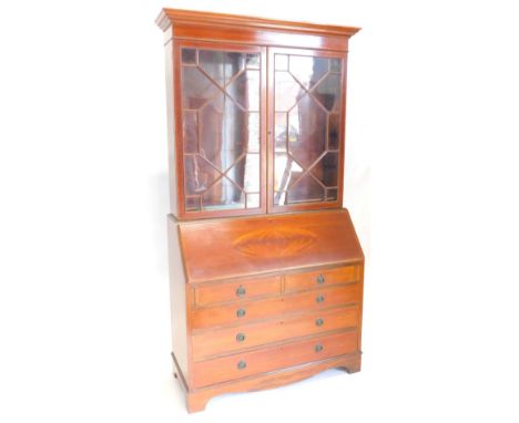 An Edwardian mahogany and rosewood cross banded bureau bookcase, the top with a moulded cornice with two astragal glazed door