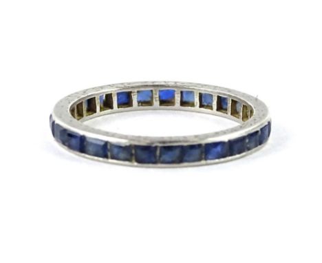 A sapphire eternity ring, set with varying sized square cut sapphires, in white metal setting, unmarked, ring size O, 2.6g al