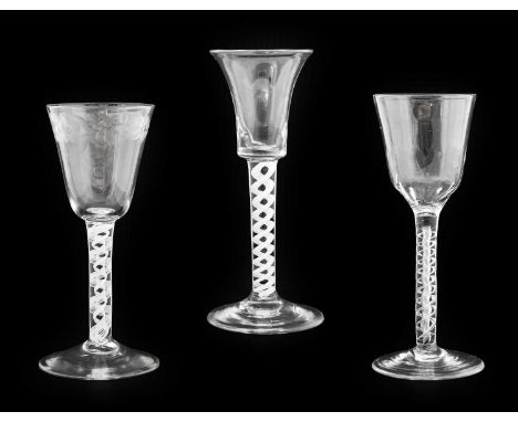 A Wine Glass, circa 1750, the rounded funnel bowl engraved with a band of foliage on an opaque twist stem15.5cm highA Similar