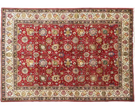 Tabriz CarpetNorth West Iran, circa 1950The raspberry field with an allover design of large palmettes and flowerheads connect