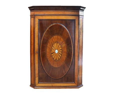 A Late George III Satinwood, Tulipwood, Purpleheart and Ebony-Crossbanded Hanging Corner Cupboard, early 19th century, the mo