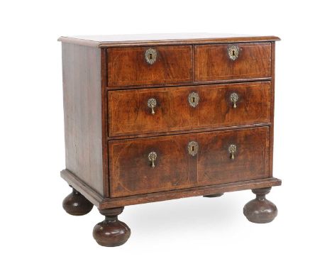 A William III Walnut and Tracery-Strung Straight-Front Chest of Drawers, circa 1700, the moulded, crossbanded and quarter-ven