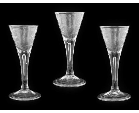 A Set of Three Wine Glasses, circa 1740, the trumpet bowls engraved Roger Beilby within foliate cartouche on plain stems with