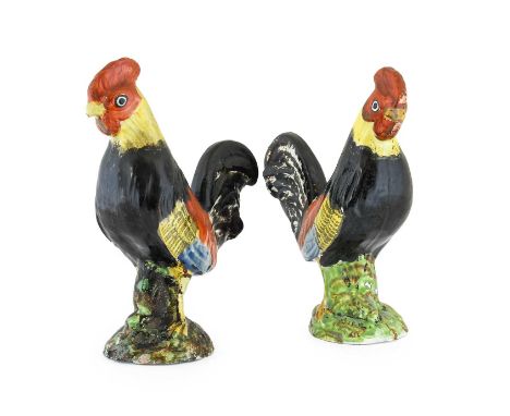 A Pair of Staffordshire Pearlware Figures of Cockerels, circa 1800, naturalistically modelled and painted on mound bases21.5c
