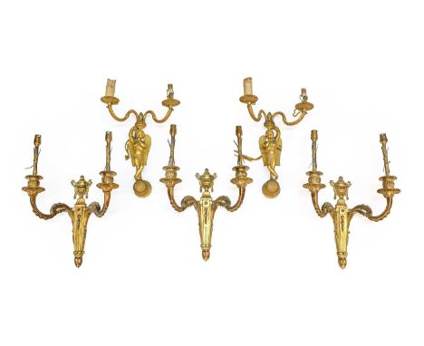 A Pair of French Gilt Metal Twin-Light Wall Sconces, in Louis XVI style, with leaf-sheathed scroll branches on angel backplat