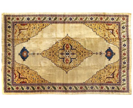 Tabriz CarpetNorth West Iran, circa 1930The soft gold field centred by a stepped anchor medallion framed by spandrels of angu