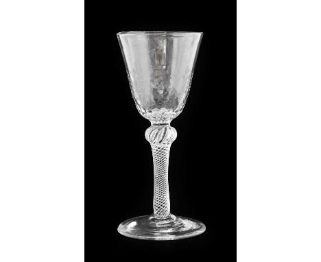 A Wine Glass, circa 1745, the rounded funnel bowl with hammered and fluted base, on a shoulder knopped air twist stem16.5cm h