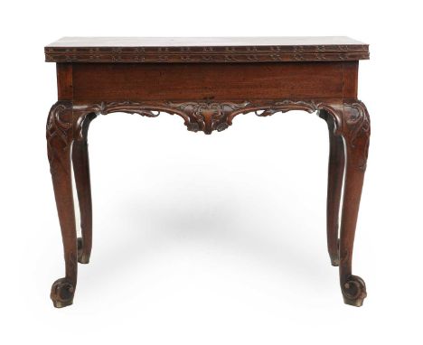 A George III Carved Mahogany Chippendale-Style Foldover Tea Table, circa 1760, of rectangular form, the hinged leaf and doubl