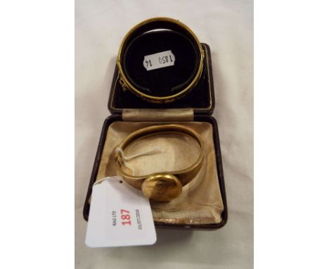 A Damascene bangle with bird and leaf design and a pinchbeck mourning locket bangle with engraved design