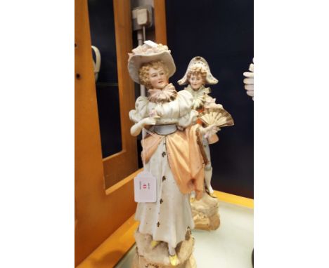 A pair of continental porcelain figures in Regency dress