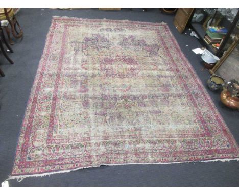 A worn pink ground Persian carpet 374 x 276cm