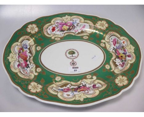 A large Chamberlains Worcester oval meat plate, the green ground with gilt cartouches of flowers and central armorial of a tr