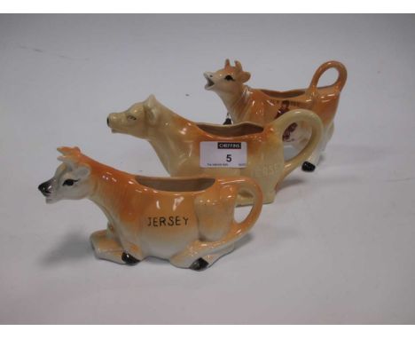 A collection of 20th century cow creamers, a pair of printed vases, 2 Royal Worcester cups, saucers and a miniature R C Derby