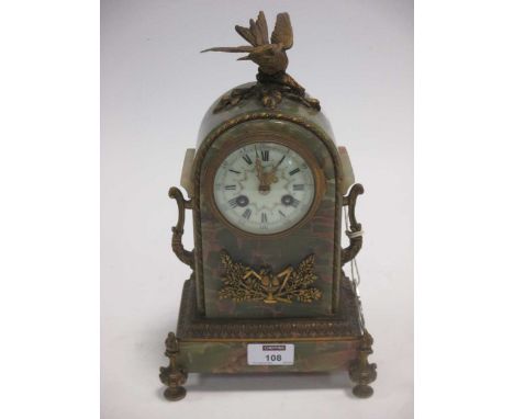 An early 20th century French onyx mantle clock with ormolu mounts and bird crest, 30 cm