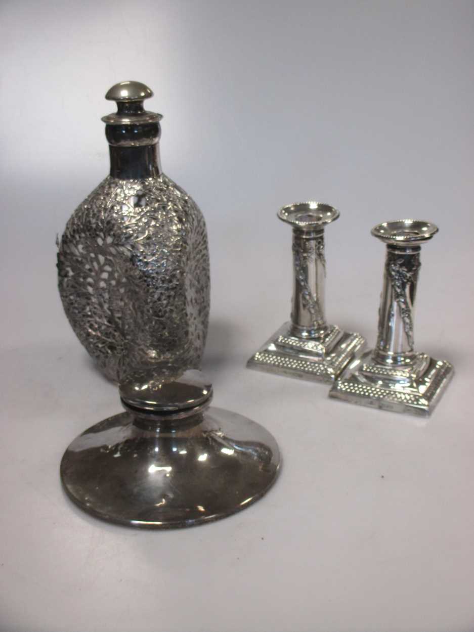 A sterling mounted glass decanter with stopper (some loss of silver
