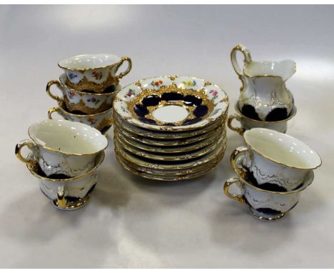 A Meissen tea service for eight, decorated with scattered floral sprays within cobalt blue borders, comprising cups, saucers 