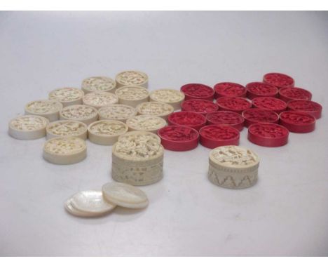 A set of Chinese carved ivory playing pieces, two boxes with mother-of-pearl counters