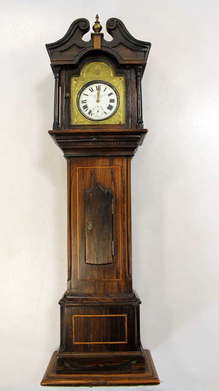 A 19th century rosewood pocket watch holder in the form of a miniature